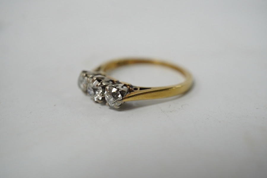 An 18ct gold and three stone diamond set ring, size K, gross weight 2.4 grams. Condition - fair to good